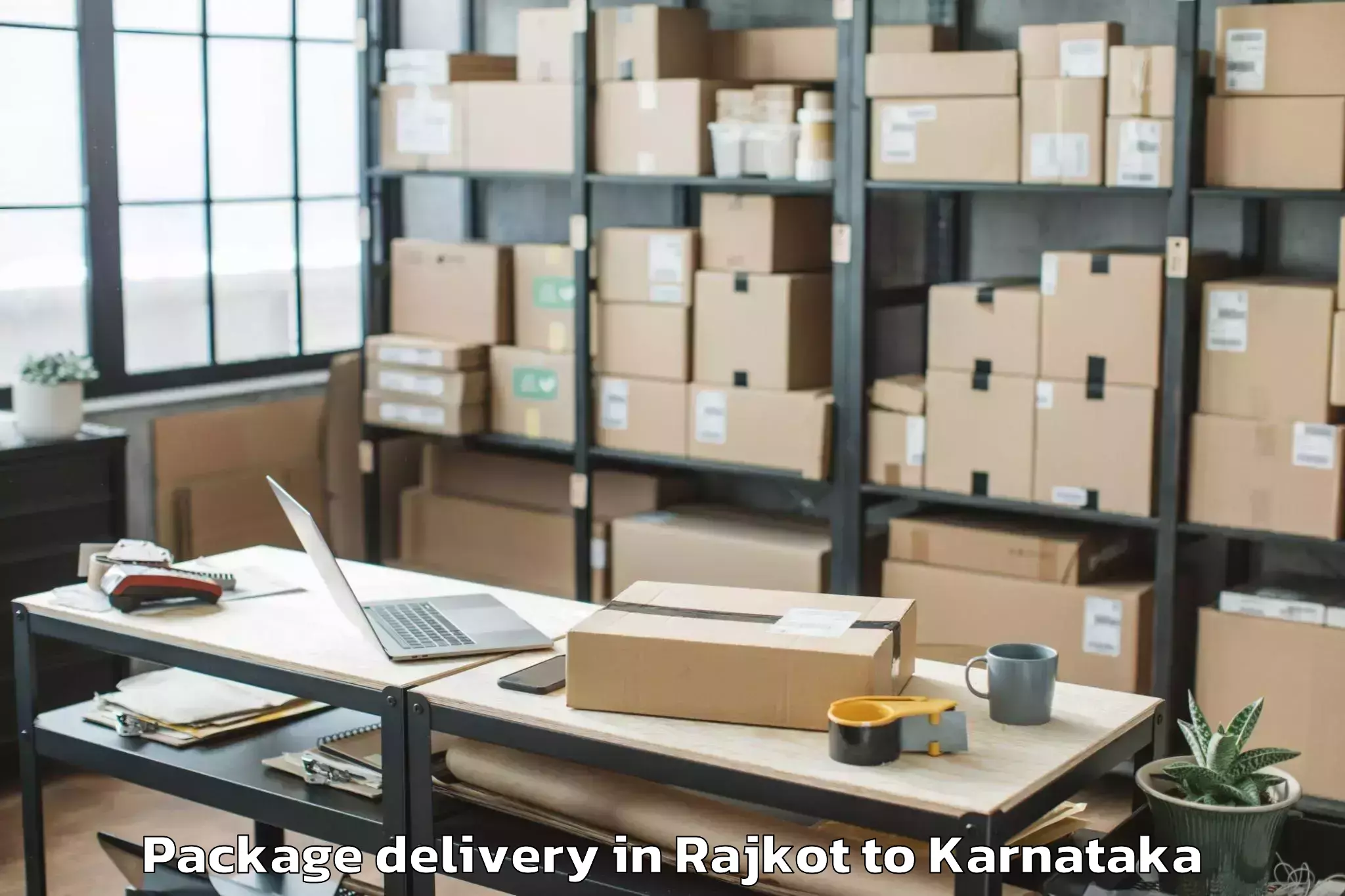 Top Rajkot to Karnataka Janapada Vishwavidya Package Delivery Available